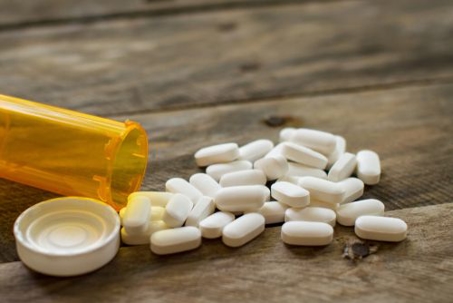 Pill Bottle with Pills on Table