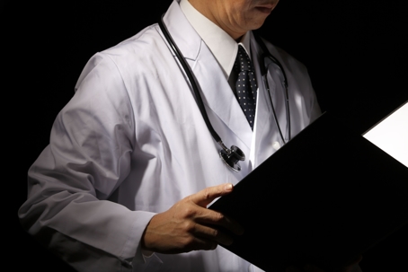 doctor holding medical records with face obscured